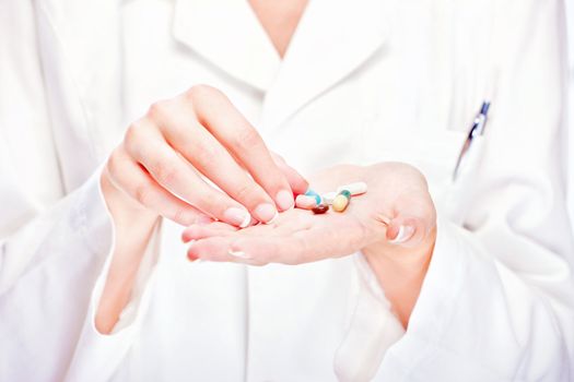 Pills in hands of a female nurse