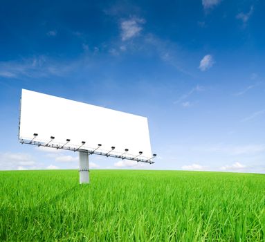 an empty billboard on a green field