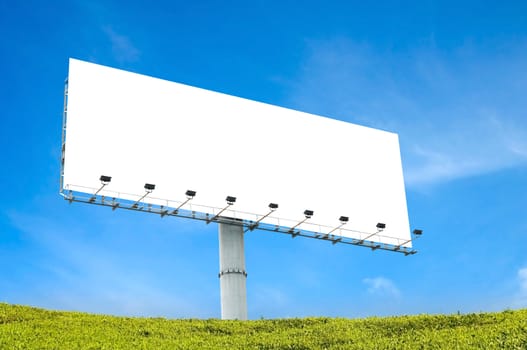 blank billboard with blue sky and green grass