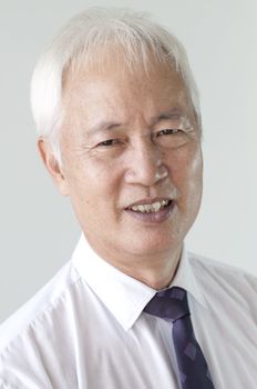 portrait photo of old senior asian business man smiling 