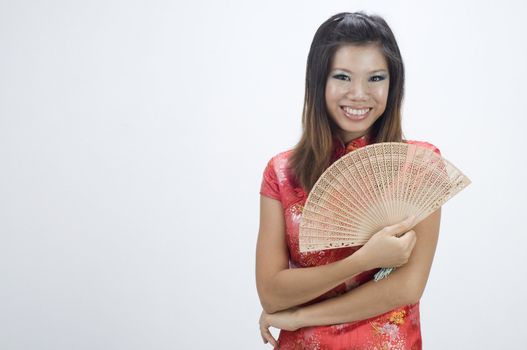 chinese girl with cheong sam and a fan
