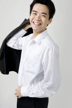 young asian business man smiling with a coat 