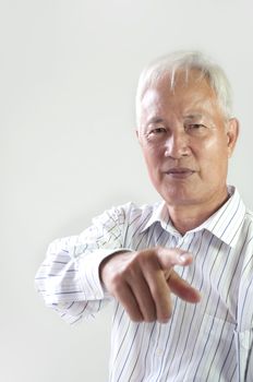 portrait of a senior asian man pointing