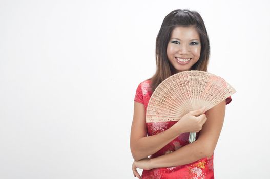happy chinese girl with fan duing chinese new year