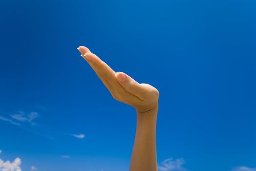 hands facing up over blue sky