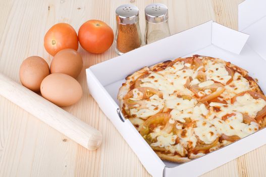 tomato supreme pizza with kitchen background
