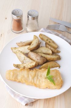 fish and chips meal on a wooden table