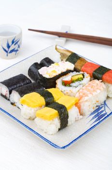 various sushi set with chopstick and tea