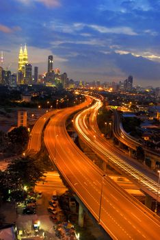 famous landmark of kuala lumpur with fast moving vehicle on highway