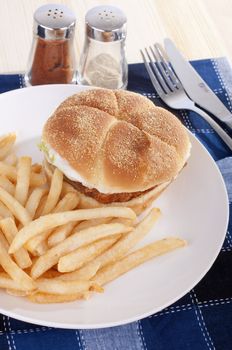 fish and chips meal on a wooden table and blue table cloth