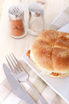 fish burger meal with fork and knife