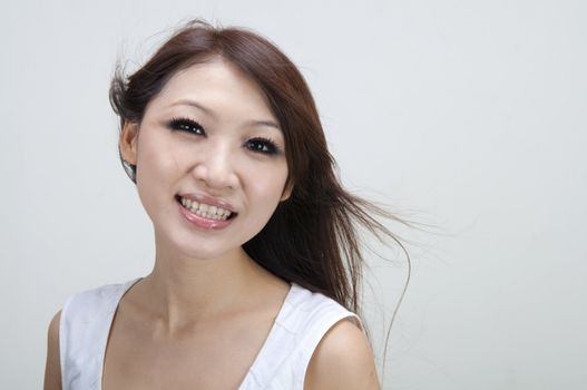 asian girl smiling with plain background