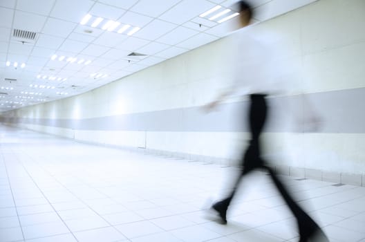 motion blur of people walking in blue tone 