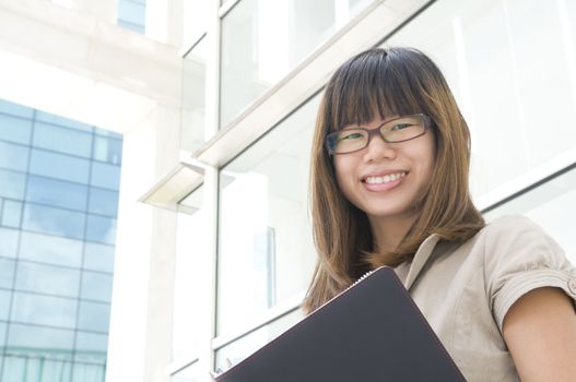 young asian business women holding a folder and smiling 
