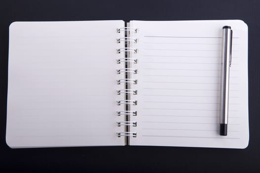 notepad with a pen