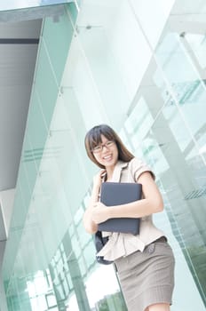 young asian business women smiling with a notepad 