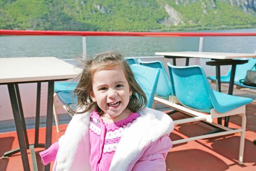 playful pretty little girl on sail boat in Lugano