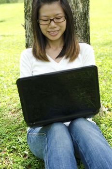 asian girl using laptop on outdoor 