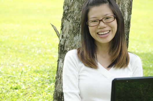 asian girl using laptop on outdoor 