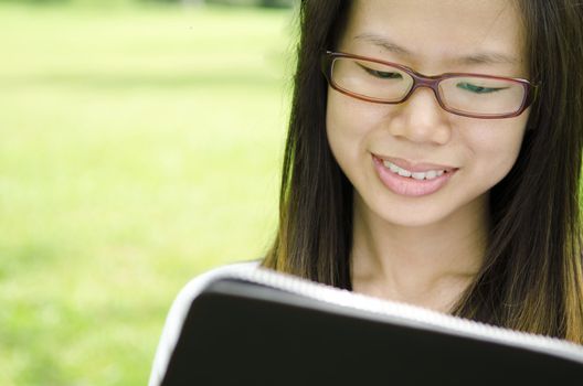 asian girl using notebook on outdoor