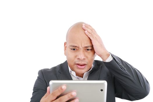 Shocked young business man with a tablet isolated on the white