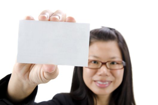Asian businesswoman holding a blank business card and smiling at the camera 