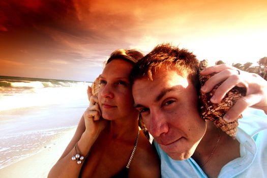young man and pretty girl speak by shell phones