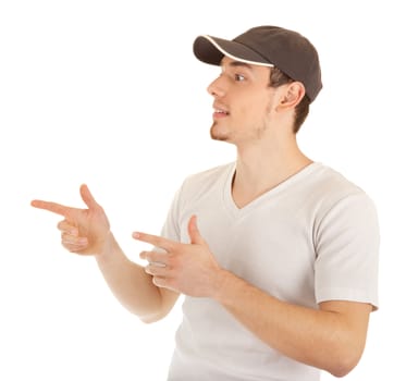 Casual young man in a hat is pointing sideways. Isolated on white.