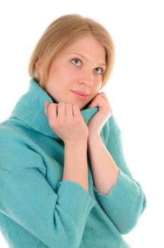 Young blonde woman with green eyes is warming herself by woollen sweater isolated on white background