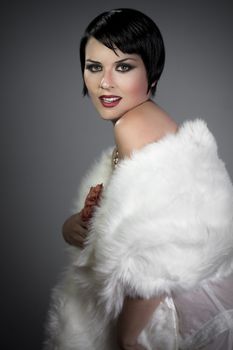sensuous short haired brunette woman, bare shoulders with white fur, flirty, 20s hollywood style