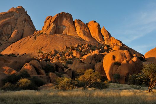 Spitzkoppe in Namibia at sunset. The sandstone becomes a deep orange during sunset