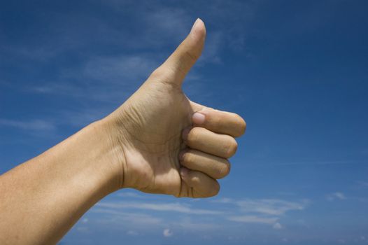 thumbs up over blue sky