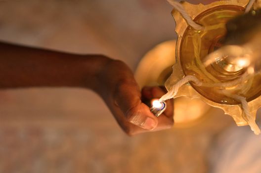 indian hand lighting diwali lamp , focus on lights only, Diwali is end this month