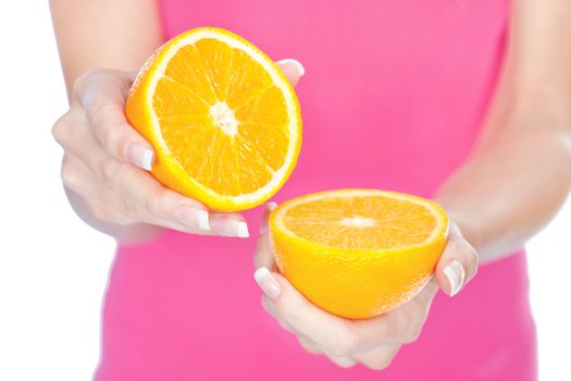 woman's hands holding two slice of orange