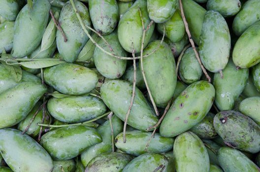 stack of mangoes for sale on the market