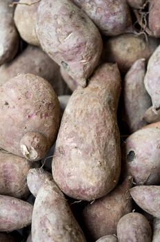 a stack of sweet potato for sale in the market 