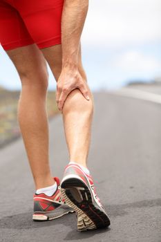 Cramps in leg calves or sprain calf on ttriathlete runner. Sports injury concept with running man.