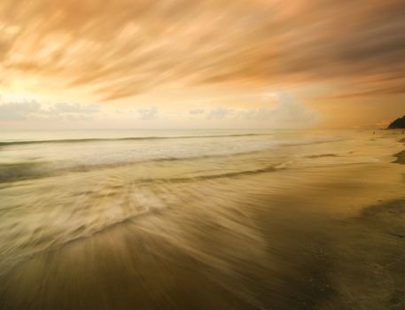 fast moving clouds on beach sunset