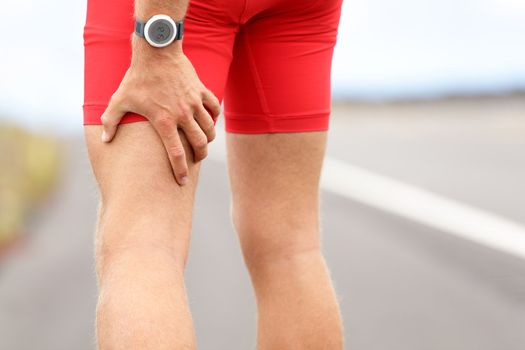 Hamstring sprain or cramps. Running sports injury with male triathlete runner.