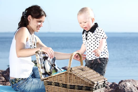 happy mother and son on picnic near sea