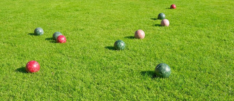A grassy lawn area with 10 Bocce Balls at a Resort