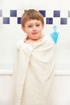 Young boy at bath time in a towel