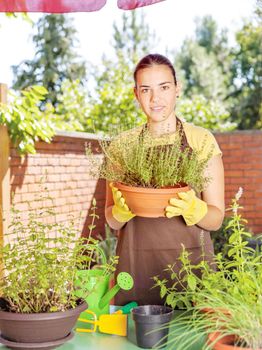 A young woman in a garden jobs on a sunny day