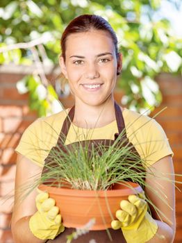 A young woman in a garden jobs on a sunny day