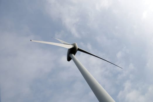 Wind turbine propeller and a gray cloudy sky