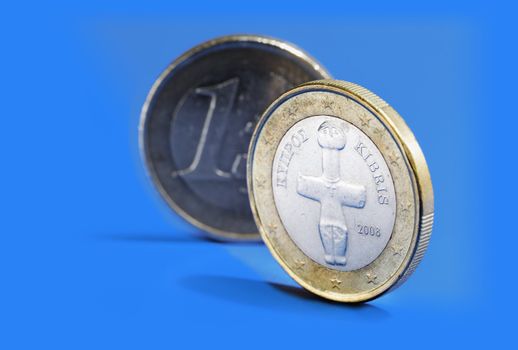 Euro coins from Cyprus on blue background.