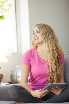 young beautiful happy woman using tablet at home