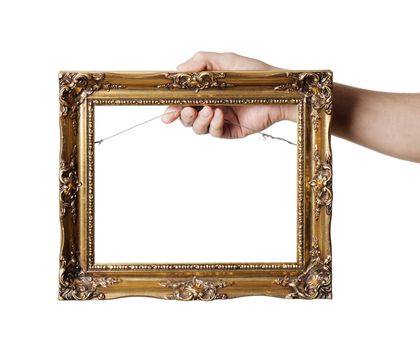 Man holding antique style golden color picture frame in his hand.