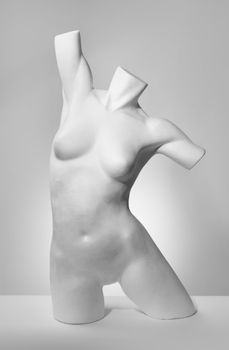 Black and white photo of an old fashion mannequin torso made of polystyrene.