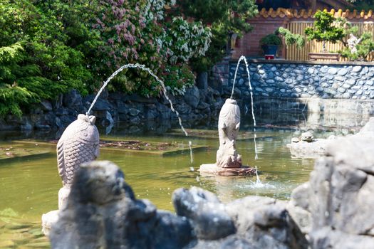 Pool and fountain in a Buddhist garden.